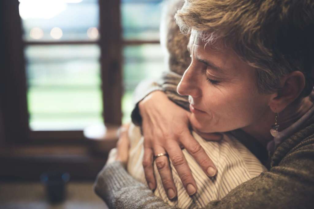 woman hugging a loved one