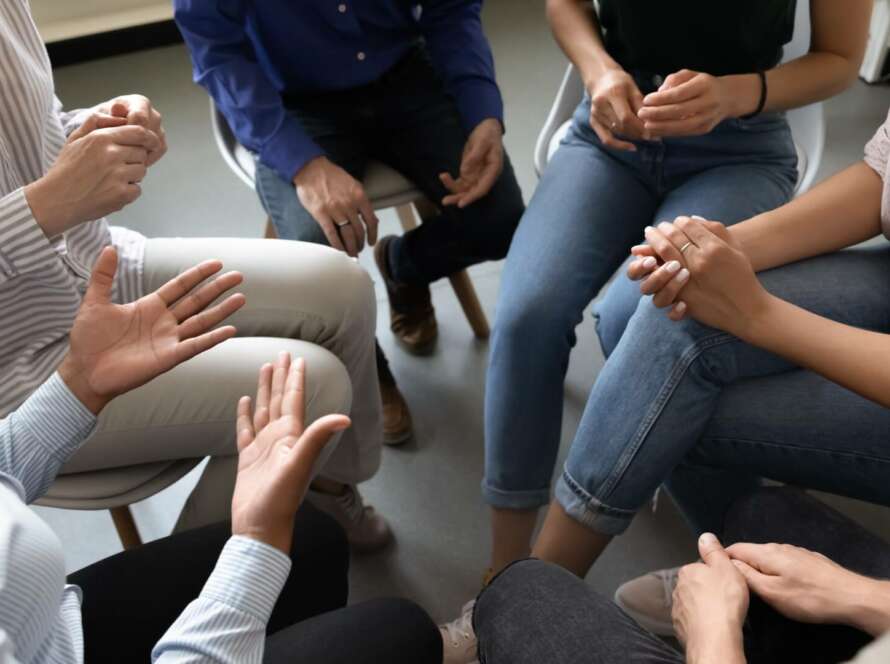 people sitting in a circle in group therapy